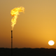 A lonely gas flare as the sun rises.
